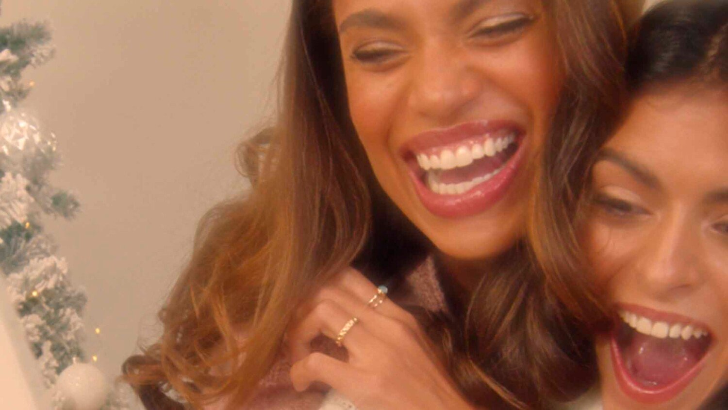 Lipsy Christmas Campaign Film two women laughing together in warm festive setting